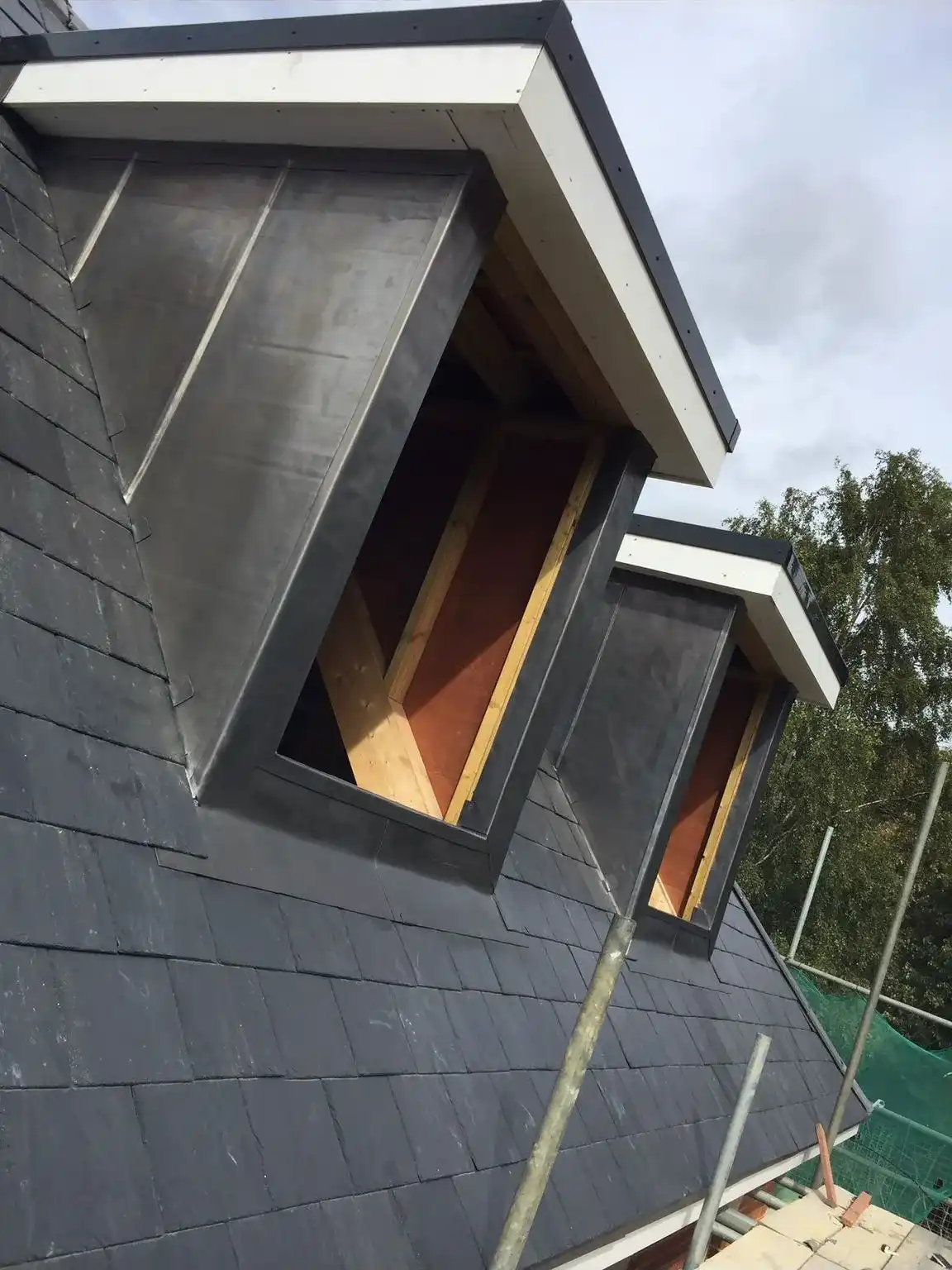A house with a roof that has a window in it.
