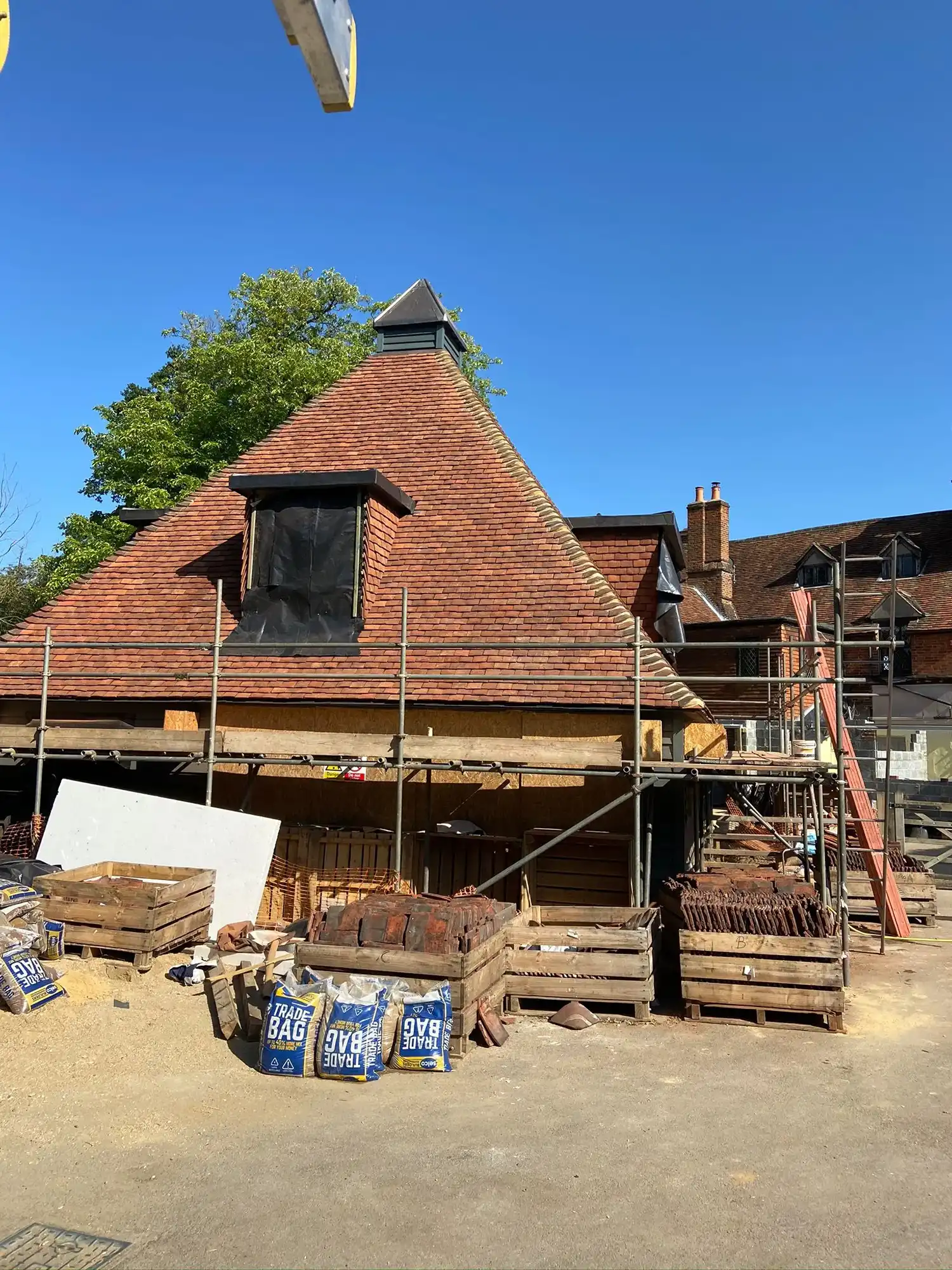 A house under construction with scaffolding around it.