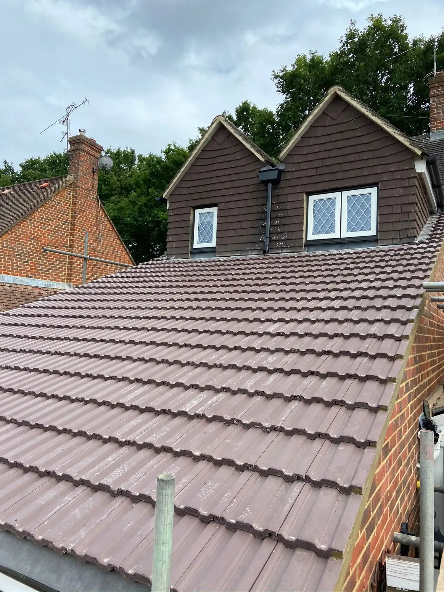 A house with a brown roof and two windows.