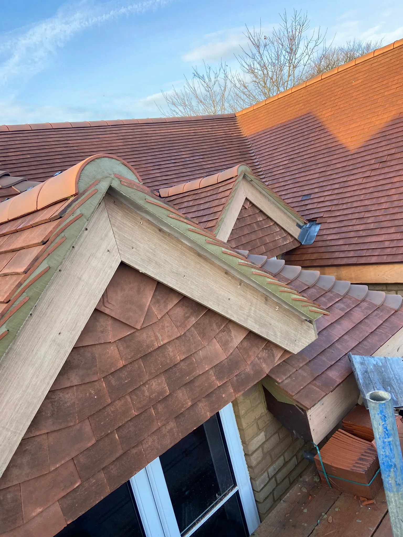 A brown roof with a bird on top of it.