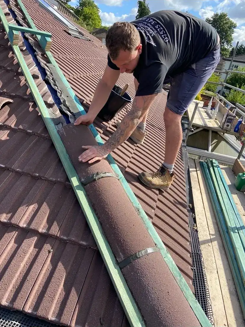 A man working on a metal roof.