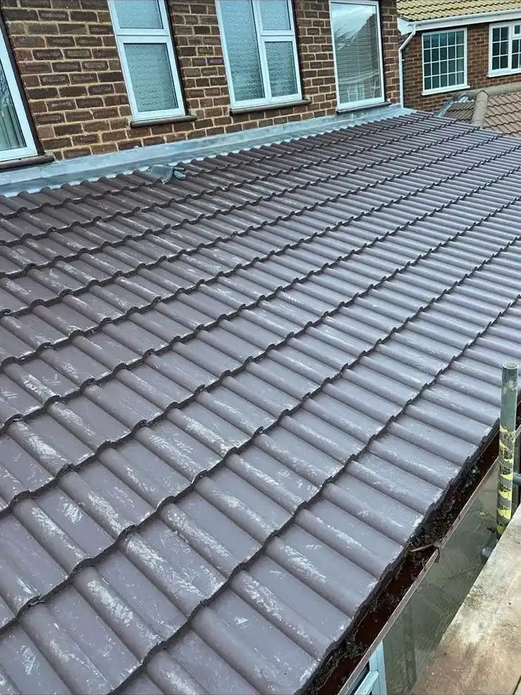 A house with a roof that has a large amount of tile on it.